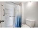 Clean bathroom with a shower stall, grab bars, and stylish blue shower curtain at 401 S Kalispell Way # 206, Aurora, CO 80017