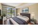 Cozy bedroom with balcony access, built-in shelves and hardwood floors, offering a relaxing retreat at 401 S Kalispell Way # 206, Aurora, CO 80017
