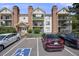 Exterior of an apartment building with balconies, brick accents, and accessible parking at 401 S Kalispell Way # 206, Aurora, CO 80017