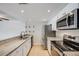 Updated kitchen boasts granite countertops, tile flooring, stainless steel appliances and ample natural light at 401 S Kalispell Way # 206, Aurora, CO 80017