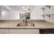 Bright kitchen featuring granite countertops and stainless steel sink with black fixtures with open concept living at 401 S Kalispell Way # 206, Aurora, CO 80017