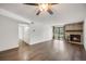 Spacious living room with hardwood floors and a stone fireplace leading to a balcony with bright natural light at 401 S Kalispell Way # 206, Aurora, CO 80017