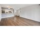 Open-concept living and dining area with modern kitchen appliances and hardwood floors, perfect for entertaining at 401 S Kalispell Way # 206, Aurora, CO 80017