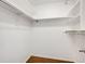 Empty walk-in closet with clothing rods and shelves at 401 S Kalispell Way # 206, Aurora, CO 80017