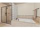 Serene bathroom featuring a separate glass-enclosed shower and a luxurious soaking tub at 2714 Calmante Pl, Superior, CO 80027