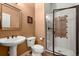 Well-lit bathroom features a glass enclosed shower and pedestal sink at 2714 Calmante Pl, Superior, CO 80027