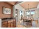 Elegant dining room with hardwood floors, a large table, and a stylish chandelier featuring a wet bar at 2714 Calmante Pl, Superior, CO 80027