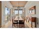 Spacious dining room with hardwood floors, a large dining table, and views of the outdoors through large windows at 2714 Calmante Pl, Superior, CO 80027
