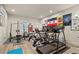 Home gym featuring a treadmill, stationary bikes, and weightlifting equipment, promoting a healthy lifestyle at 2714 Calmante Pl, Superior, CO 80027