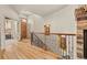 Elegant foyer with hardwood floors, an ornate iron railing, and lots of natural light at 2714 Calmante Pl, Superior, CO 80027