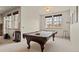 Spacious game room with a pool table, large windows, and natural light, perfect for entertaining at 2714 Calmante Pl, Superior, CO 80027