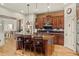 Bright kitchen with island seating, mosaic backsplash, and view to adjacent dining area at 2714 Calmante Pl, Superior, CO 80027