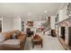 Comfortable living room with a stone fireplace, bar area, and staircase to the upper level at 2714 Calmante Pl, Superior, CO 80027