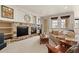 Cozy living room with stone fireplace, built-in shelves, and comfortable seating at 2714 Calmante Pl, Superior, CO 80027