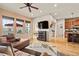 Bright and airy living room showcasing hardwood floors, large windows, and a view of the adjacent dining area at 2714 Calmante Pl, Superior, CO 80027