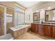A luxurious bathroom boasts a soaking tub, a walk-in shower, and double vanity sinks at 7472 Iridium Way, Castle Rock, CO 80108
