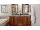 The bathroom features dual sinks with granite countertops and wooden cabinetry at 7472 Iridium Way, Castle Rock, CO 80108