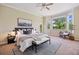 Spacious bedroom with neutral colors and floor to ceiling windows with wooded view at 7472 Iridium Way, Castle Rock, CO 80108