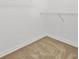 Empty walk-in closet features basic shelving and tan carpet at 7472 Iridium Way, Castle Rock, CO 80108