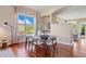 Dining area features hardwood floors, neutral colors and an open space to living room at 7472 Iridium Way, Castle Rock, CO 80108