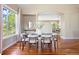 Elegant dining area featuring hardwood floors, modern lighting, and a view of the backyard at 7472 Iridium Way, Castle Rock, CO 80108