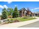 Beautifully landscaped front yard and brick exterior creates great curb appeal at 7472 Iridium Way, Castle Rock, CO 80108