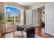 Well-lit home office with classic design featuring a desk and large window views at 7472 Iridium Way, Castle Rock, CO 80108