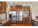 Modern kitchen with stainless steel appliances, wooden cabinets, and granite countertops at 7472 Iridium Way, Castle Rock, CO 80108