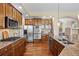 Gourmet kitchen boasts custom wood cabinetry, stainless appliances, and granite countertops at 7472 Iridium Way, Castle Rock, CO 80108