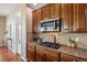This kitchen boasts granite countertops, wood cabinetry, and stainless steel appliances at 7472 Iridium Way, Castle Rock, CO 80108