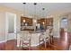 Open kitchen with an island, bar stool seating, modern lighting, and stainless steel appliances at 7472 Iridium Way, Castle Rock, CO 80108