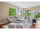 Bright living room featuring hardwood floors, large windows offering great natural light at 7472 Iridium Way, Castle Rock, CO 80108