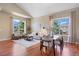 Bright living room with large windows and hardwood floors, offering ample seating and natural light at 7472 Iridium Way, Castle Rock, CO 80108
