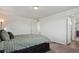 A cozy bedroom with a comfortable bed and a view into an en suite bathroom at 5121 N Yampa St, Denver, CO 80249