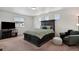 Comfortable bedroom featuring a large bed, soft carpeting, and plenty of natural light at 5121 N Yampa St, Denver, CO 80249
