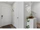 Bright entryway with white walls, wood floor, decorative mirror, and doors at 5121 N Yampa St, Denver, CO 80249