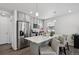 Beautiful kitchen with stainless steel refrigerator, eat in island and modern grey cabinets at 5121 N Yampa St, Denver, CO 80249