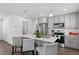 Bright kitchen boasts stainless steel appliances, modern cabinetry, and a large center island with bar seating at 5121 N Yampa St, Denver, CO 80249