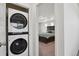 Laundry area with stacked washer and dryer located adjacent to the primary bedroom at 5121 N Yampa St, Denver, CO 80249