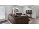 Living room with large sofa, TV, and vinyl floor at 5121 N Yampa St, Denver, CO 80249