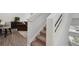 Carpeted staircase with white trim, leading to living room, with view of a chair and table at 5121 N Yampa St, Denver, CO 80249