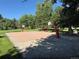Outdoor basketball court in a community area with lush trees and recreational space at 8452 Everett Way # C, Arvada, CO 80005