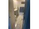 Bright bathroom featuring white marble floors, a vanity, and a toilet at 8452 Everett Way # C, Arvada, CO 80005