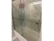 Bathroom showcasing a glass shower door with white marble walls and silver trim at 8452 Everett Way # C, Arvada, CO 80005
