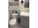 Small bathroom featuring a toilet and vanity with white walls and marble floors at 8452 Everett Way # C, Arvada, CO 80005