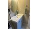 Bathroom vanity with a round mirror, modern faucet, and a stylish towel ring at 8452 Everett Way # C, Arvada, CO 80005