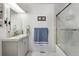 Bright bathroom featuring marble floors, gray vanity, and a glass-enclosed shower at 8452 Everett Way # C, Arvada, CO 80005