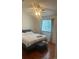 Bright bedroom with hardwood floors, white trim, and a ceiling fan at 8452 Everett Way # C, Arvada, CO 80005