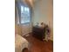 Cozy bedroom with wood floors, a dresser, and a bright window at 8452 Everett Way # C, Arvada, CO 80005