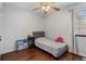 Bright bedroom with hardwood floors, ceiling fan, and a comfortable twin bed at 8452 Everett Way # C, Arvada, CO 80005